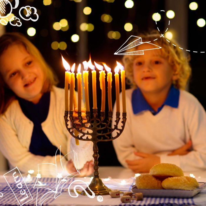 Jewish holiday Hanukkah background with vintage menorah and spinning top dreidel over lights bokeh.